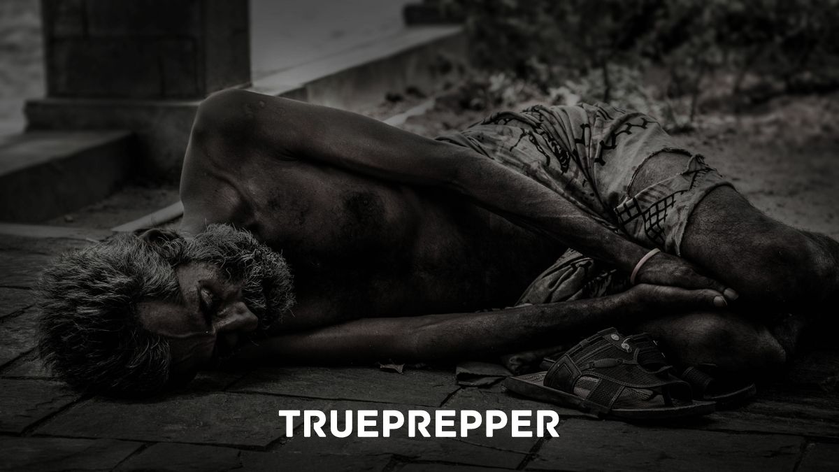 Starving man laying on sidewalk without food.