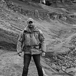 Photo of Kevin Estela standing in front of some rocky protrusions.