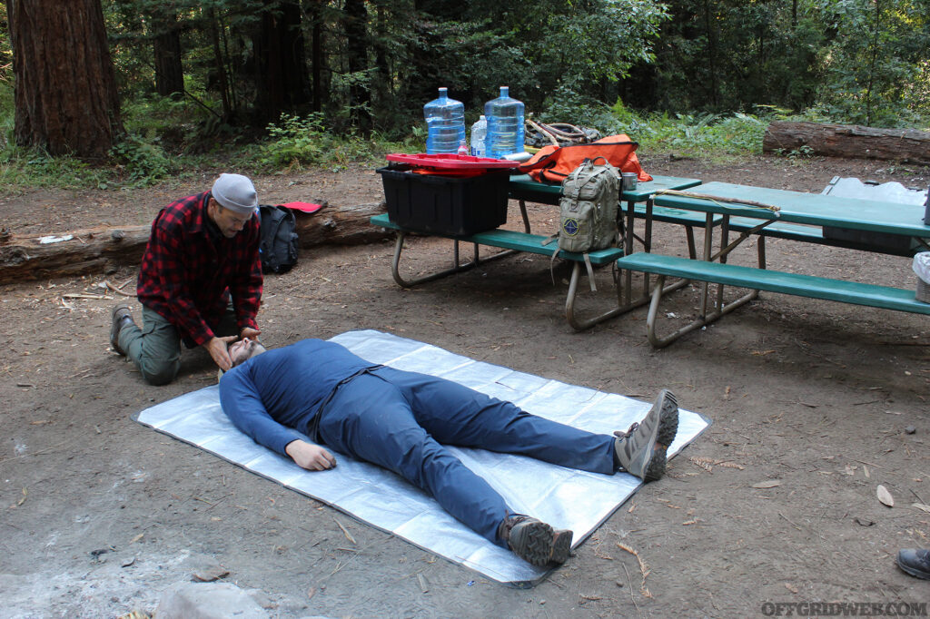 Instructor Adam Mayfield performing a casualty assessment at Coyne Survival Schools Survival Skills Certificaiton.