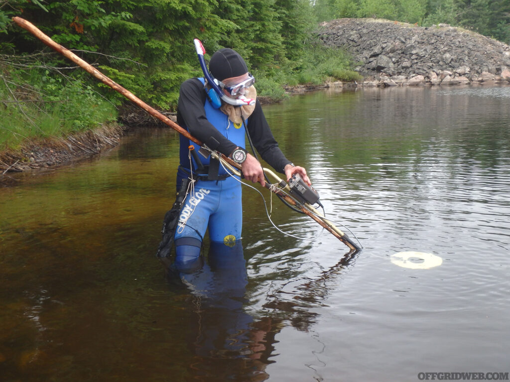 Michael Neiger searching beneath the water.