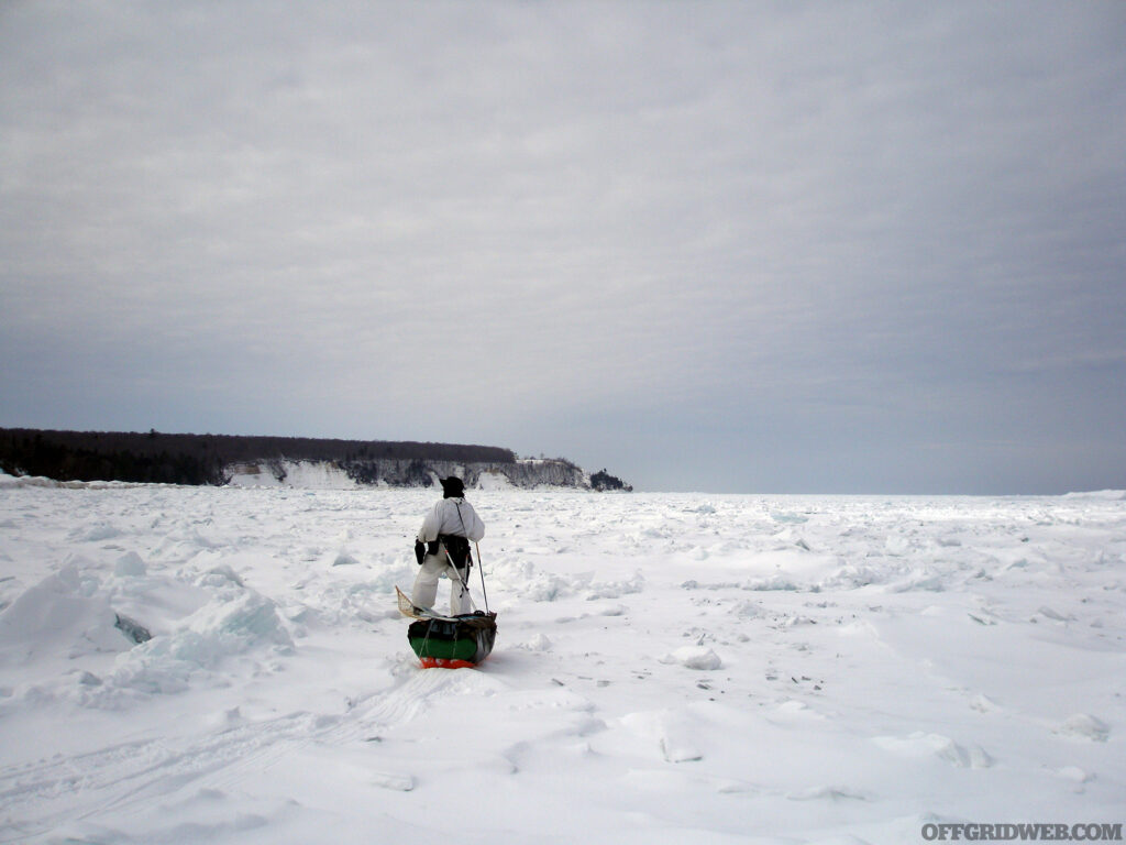 Michael Neiger pulling a toboggan over the ice.