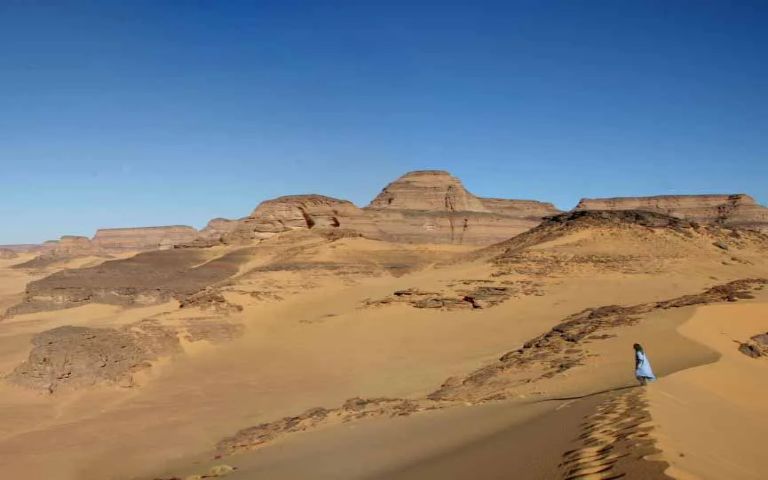 A woman at the high ground of the desert. 