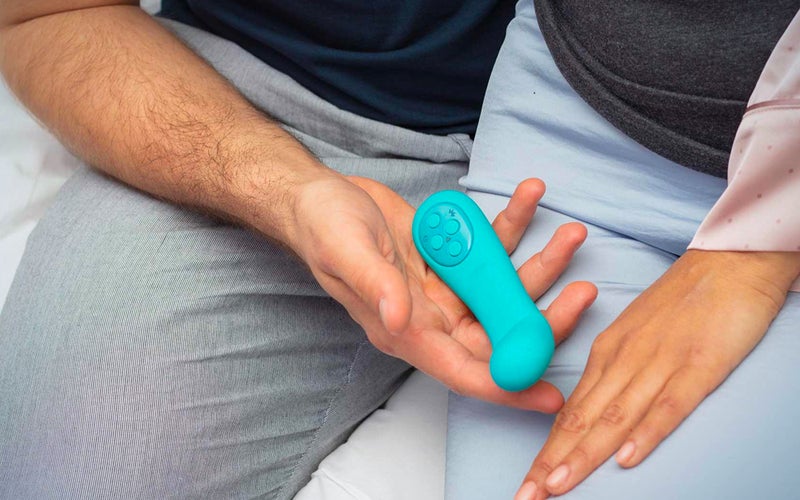 Two people holding a turquoise vibrator