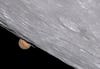 Closeup of the moon with mars peeking out behind smaller