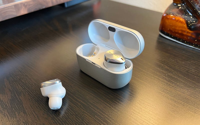 White and silver Technics AZ80 earbuds for small ears on a wood table