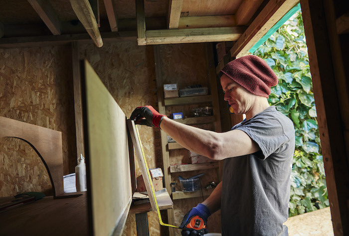 A homesteader prepping wood for a new project.