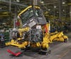 a john deere dump truck under construction in a factory