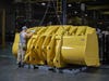 john deere yellow bucket in a factory