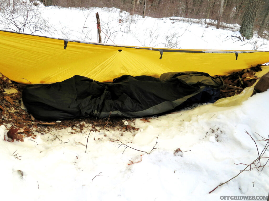Photo of a hasty winter tarp shelter.