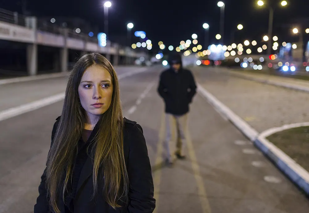 A woman being aware of a man following her.