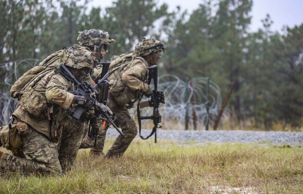 Military men doing team signals.