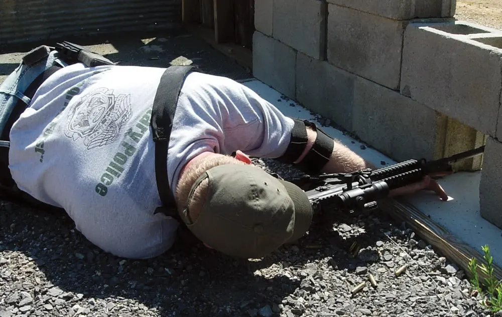 A police using cover effectively in combat situations.