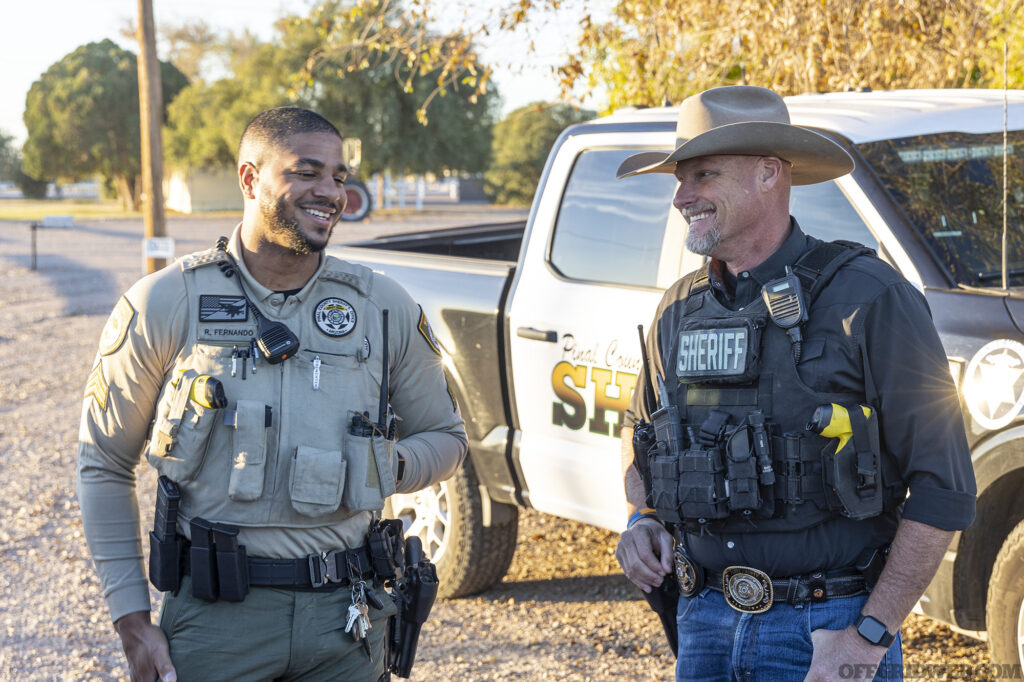 Photo of the Sheriff talking to a law enforcement partner.