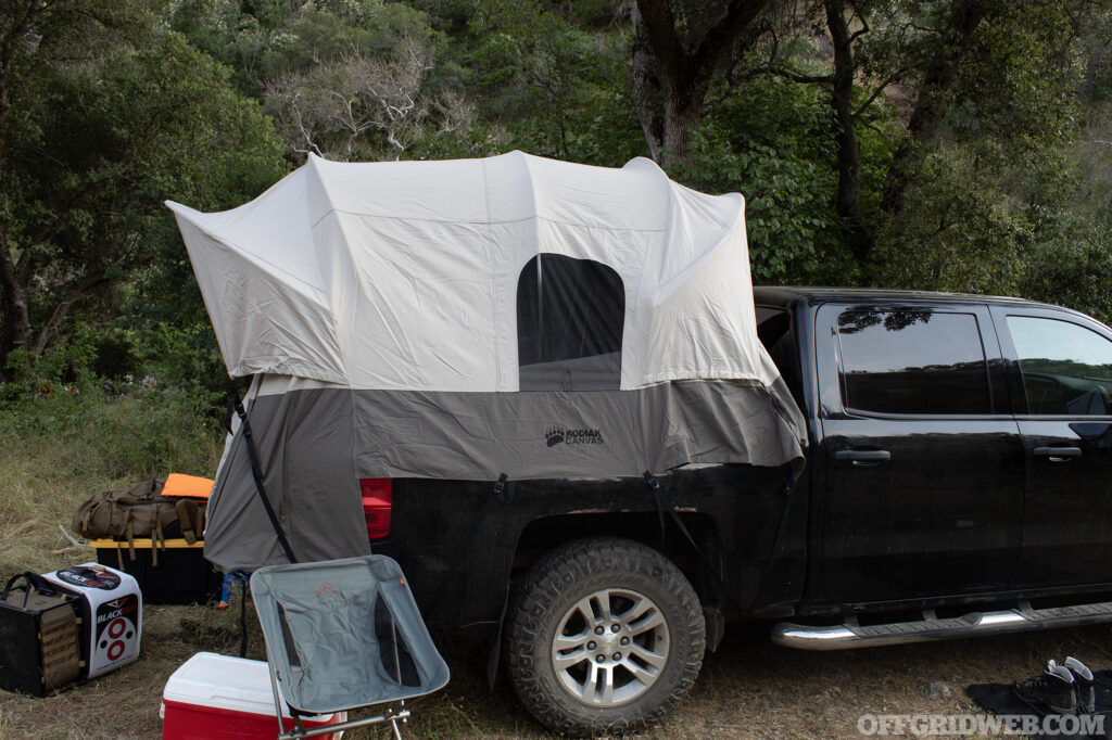 Photo of a canvas tent on the bed of a pickup truck.