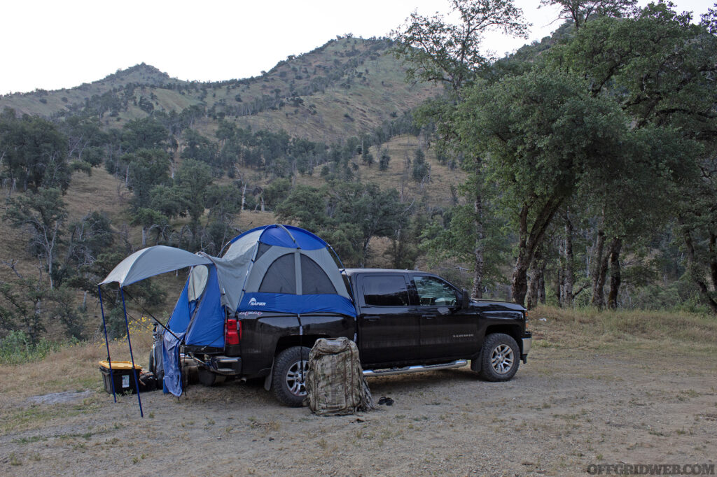 Photo of a nylon tent on the bed of a truck.